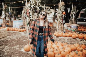 Ashley Zeal from Two Peas in a Prada shares her pumpkin patch outfit. She is wearing the Leith single button plaid coat.